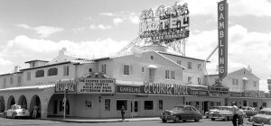 Daytime exterior photo of El Cortez with 1950s automobiles driving by